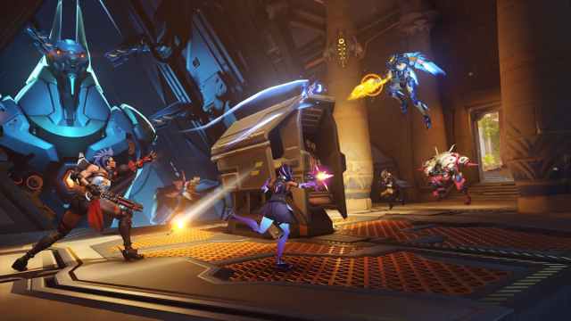 Overwatch characters fighting and running into battle, firing weapons.