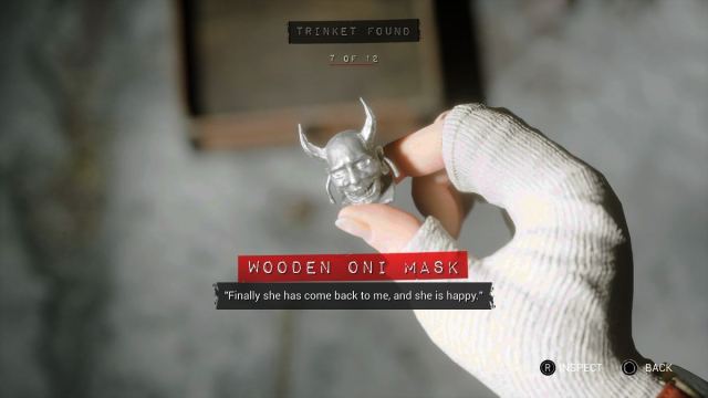 Holding the Wooden Oni Mask in a close up shot in The Casting of Frank Stone