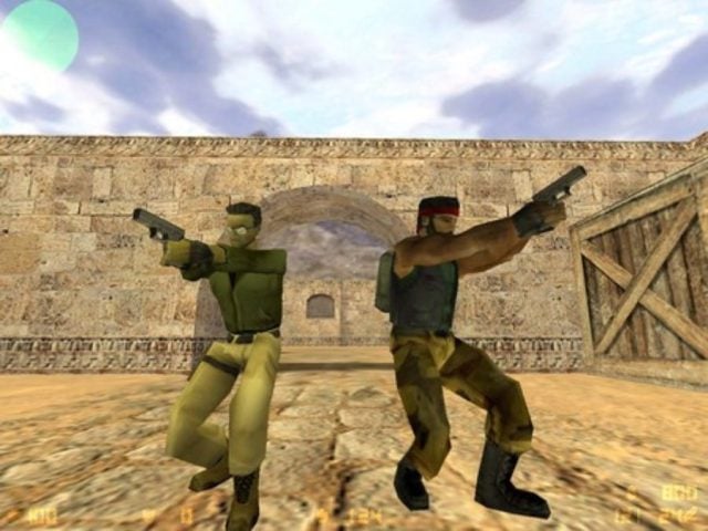 Two counter strike teammates standing next to each other, facing different directions for cover