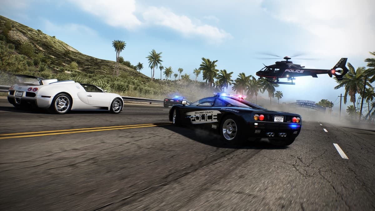 White sports car surrounded on the road by two police cars and a helicopter with trees in the background