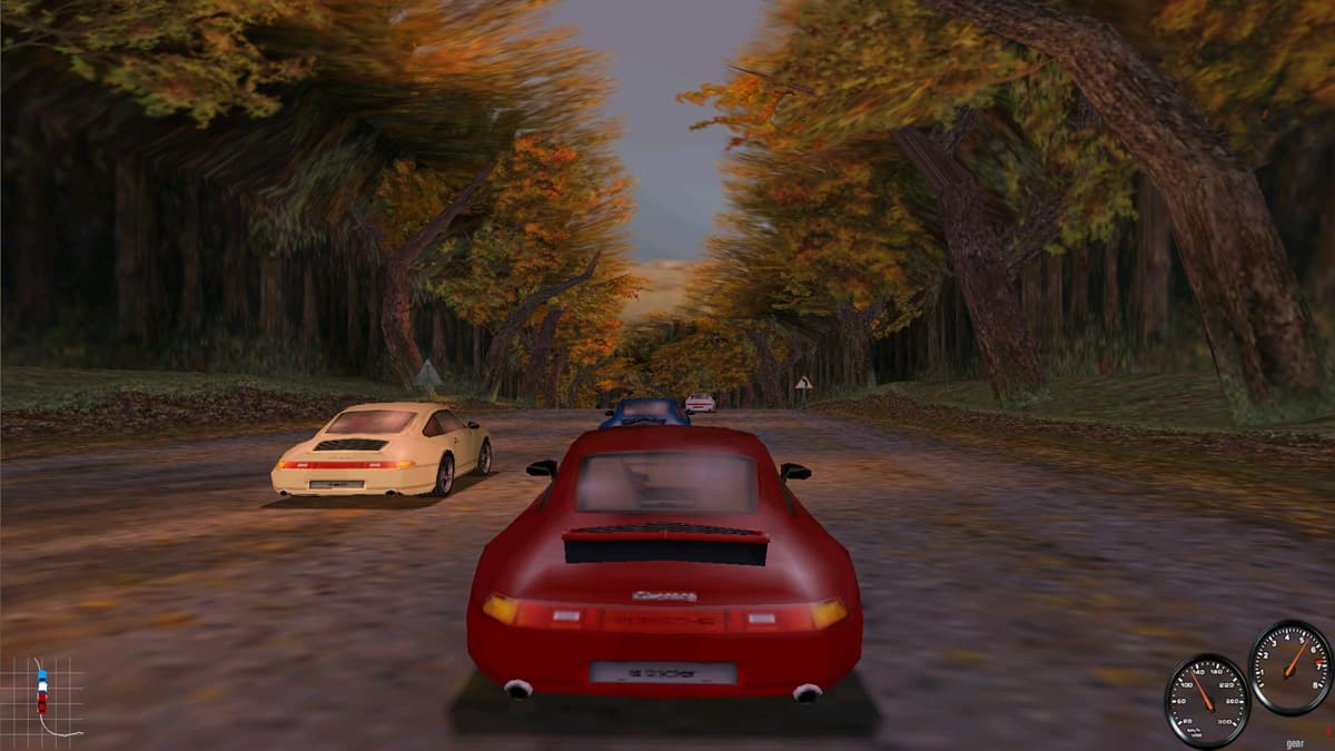 Red Porsche racing against a white Porsche and a black Porsche through a forested road