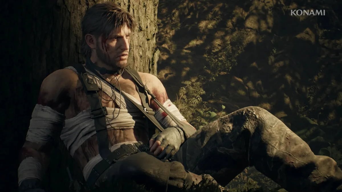 Solid Snake leans back again a tree with one arm in a sling.