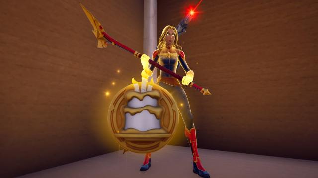 Captain Marvel standing behind a golden birthday medallion in Fortnite.