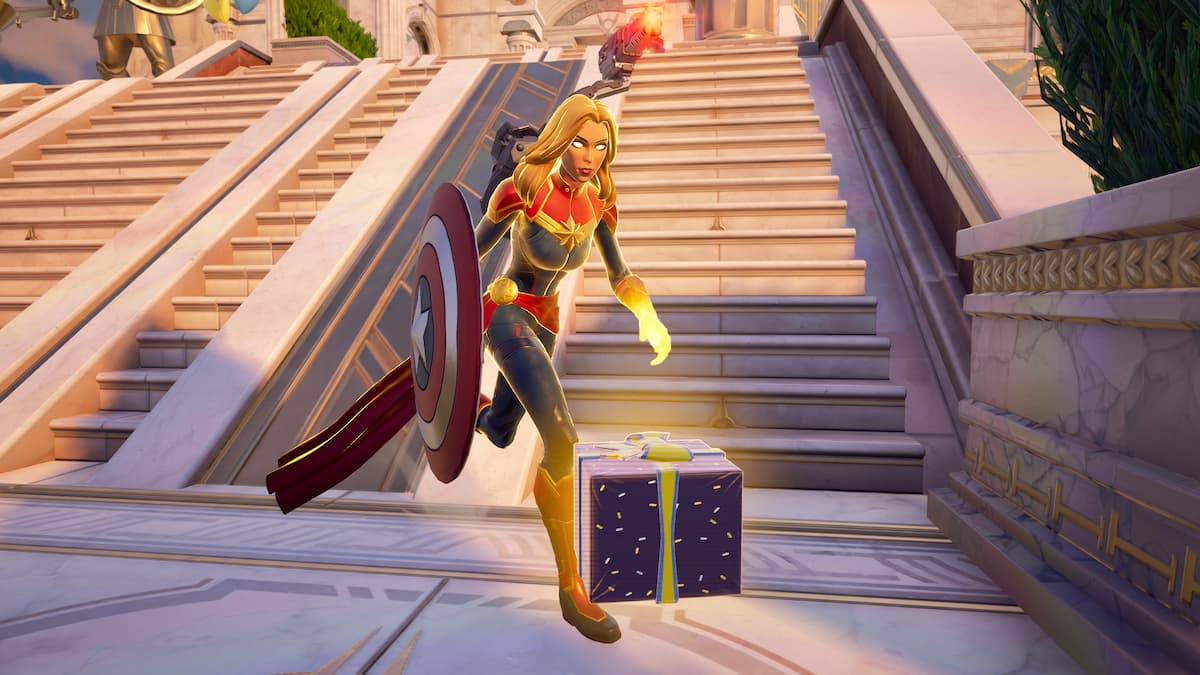 Captain Marvel running by a Birthday Present in Fortnite.