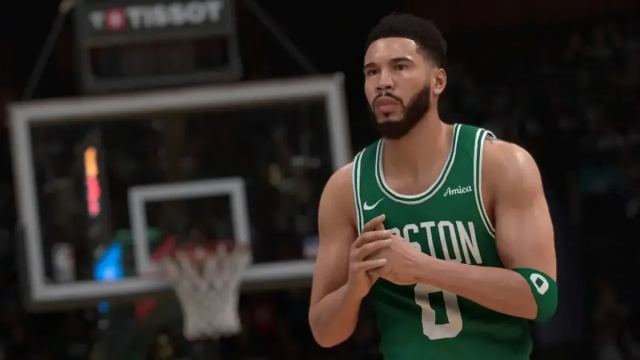 Jayson Tatum in a green Boston Celtics jersey, with his hands held together.