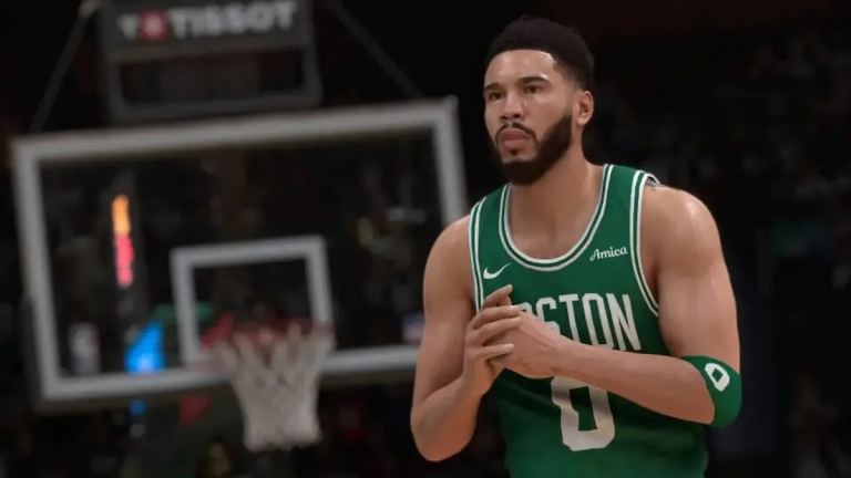 Jayson Tatum in a green Boston Celtics jersey, with his hands held together.