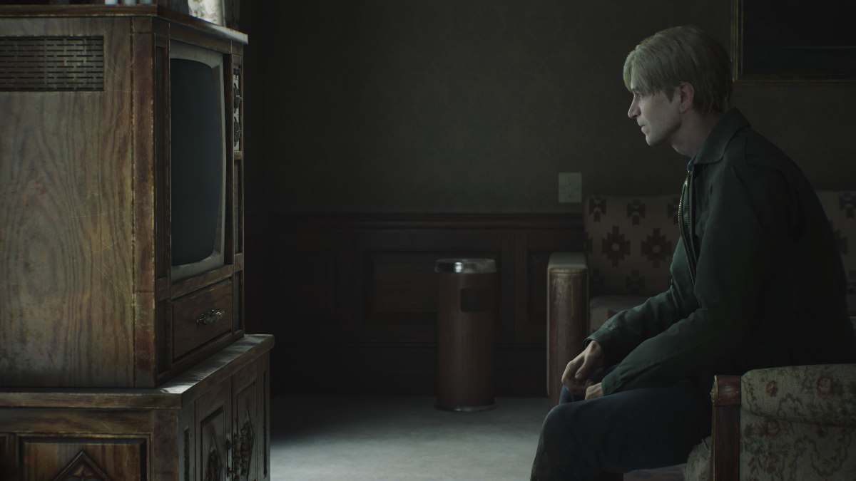 A side shot of James sitting in the chair in 317, looking at the television