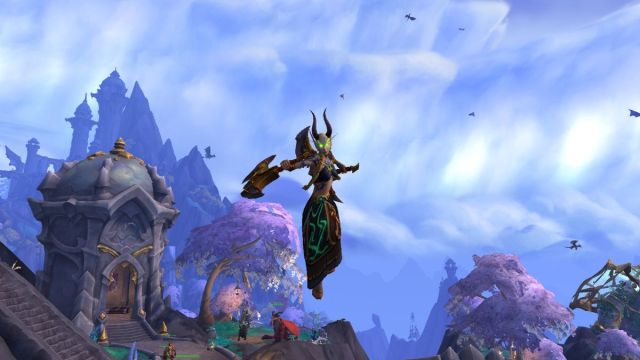 Demon Hunter leaping with weapons in World of Warcraft.