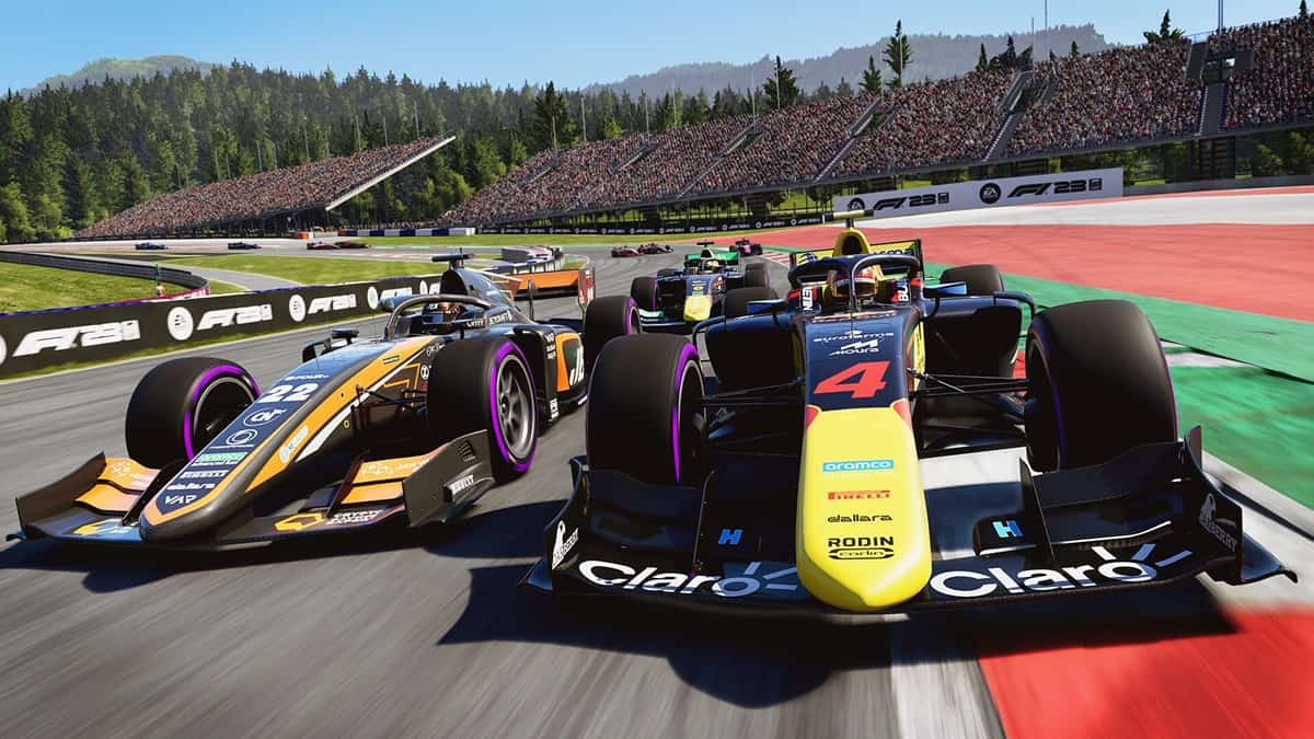 Several F1 cars racing on the track with stands of people and trees in the background