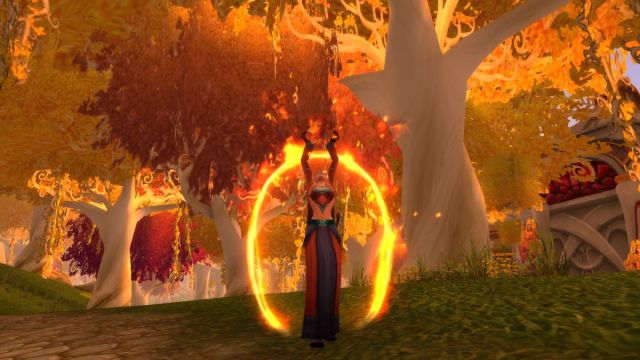 Blood Elf Mage casting a spell in a forest in World of Warcraft.