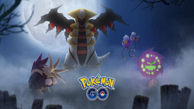 Pokemon Go Spiritomb, with Giratina and other Pokemon appearing at night above tombstones in a cemetery.