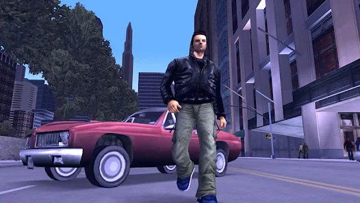 GTA 3 gameplay screenshot, featuring a man in a leather jacket and jeans walking away from a car on a city street.