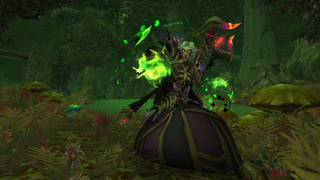 Warlock in World of Warcraft casting a spell with fel fire behind them.