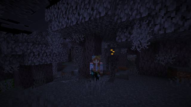 Standing next to the Creaking in a pale garden biome in Minecraft.