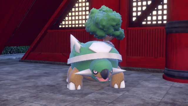 Torterra standing in front of a red building in Pokémon Scarlet and Violet.