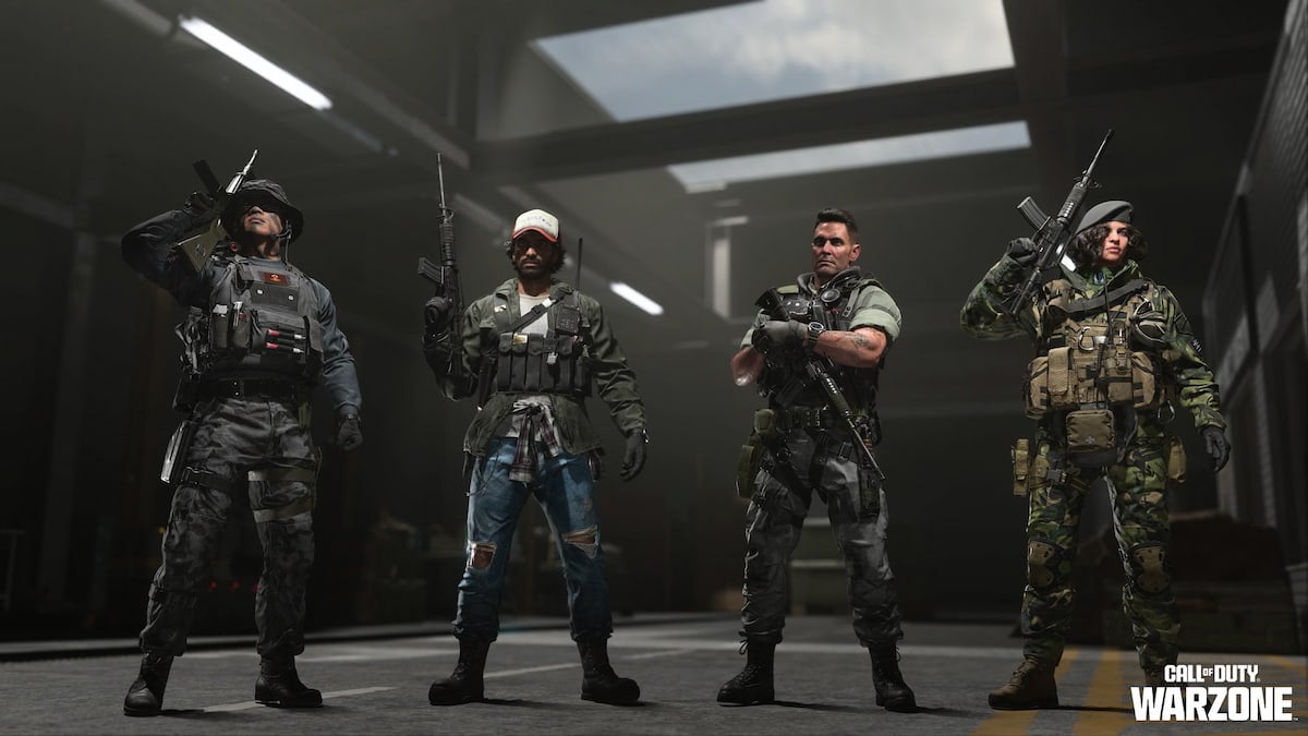 Four operators stand while holding their rifles.