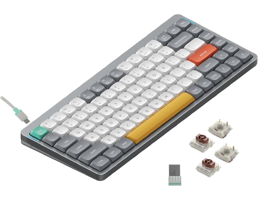 3/4 front view of the NuPhy Air75 V2. It's a gray compact keyboard with a mix of gray and white keycaps. The Enter key is coral orange, the spacebar is yellow, and the Esc key is a mint green. Also shown are the brown switches that come stock with the keyboard and the included USB dongle. More details below.