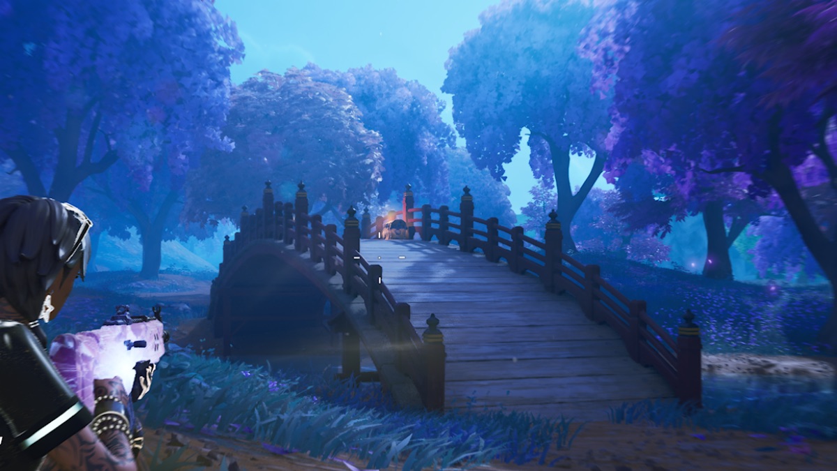 fortnite character slides towards a chest on a bridge in a forest at night