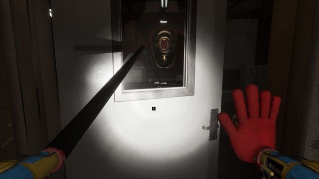 Reaching through the broken glass on the Warden Office door to pick up the VHS tape from the desk at the back