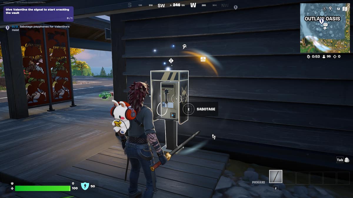 An image from Fortnite of the player looking at a payphone on a wall. You can sabotage these payphones to complete a quest.