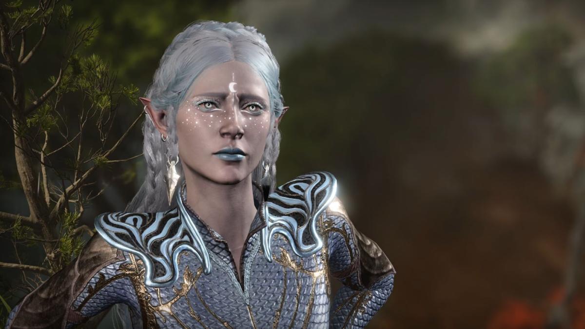 A pale and light-haired half-elf with stellar face tattoos and a blue scaled shirt frowns. Image from Baldur's Gate 3 Patch 8 photo mode showcase.