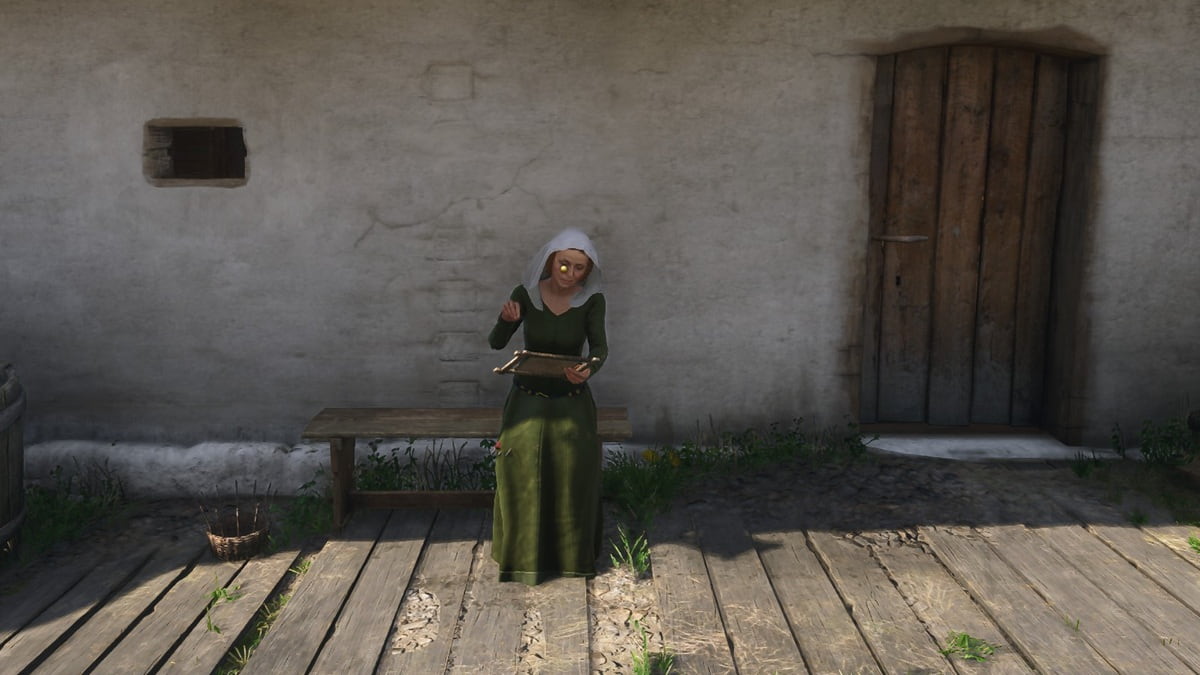 a woman sitting on a bench in front of a bath house