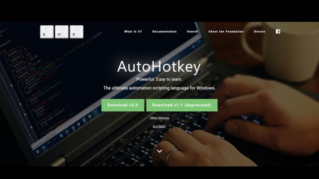 AutoHotKey website showing a person typing on a laptop