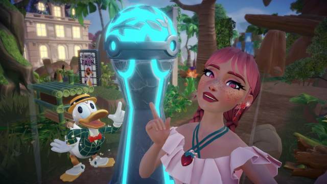 A player with pink braids and a pink strawberry dress pointing at a grey and bright blue Ancient Vacuum next to Donald Duck in Disney Dreamlight Valley