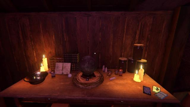 A table with candles, a crystal ball, crystals, and some Tarot Cards on it in Phasmophobia.