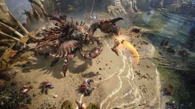 A warrior swinging an axe mid air at a massive crab on a secluded beach in Titan Quest 2.